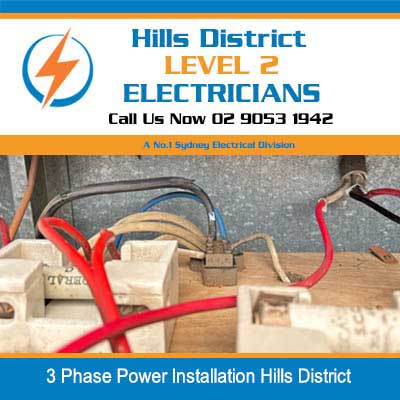 3 phase electrical components and red wiring on workbench during power installation in Hills District
