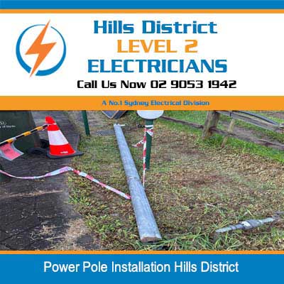 New concrete power pole base installation in residential yard in Hills District