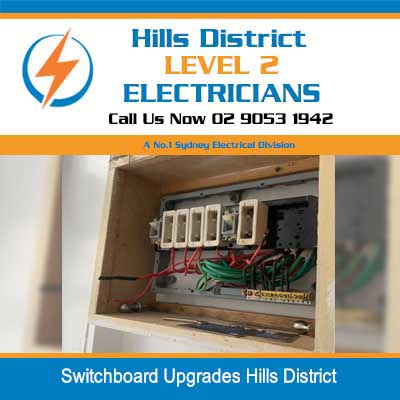 Open electrical switchboard with circuit breakers and wiring during upgrade work in Hills District