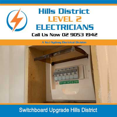 Wall-mounted electrical switchboard with circuit breakers and surge protection during upgrade in Hills District